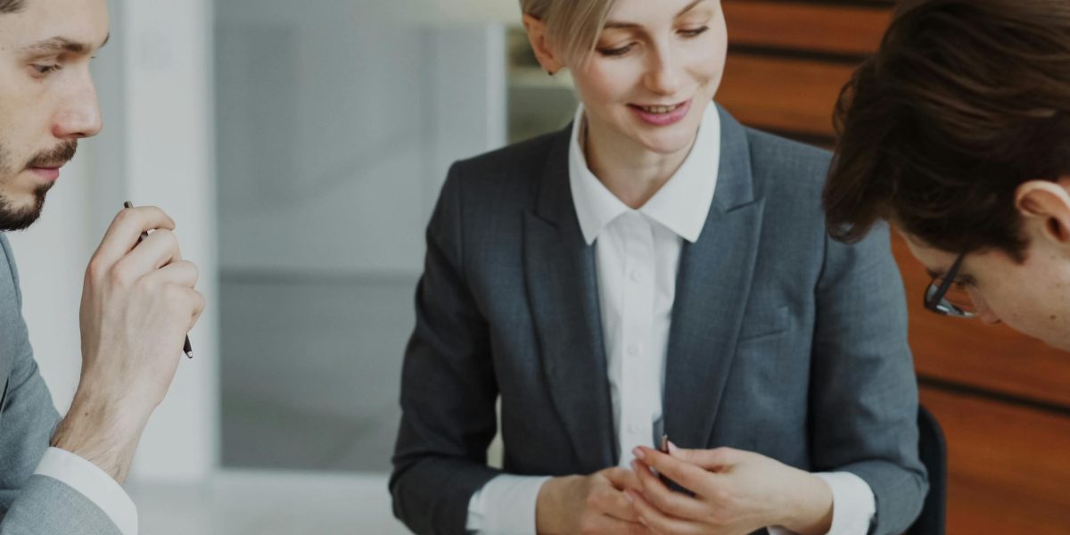 A person carefully comparing multiple business proposals, embodying the due diligence process for selecting a wealth management firm.