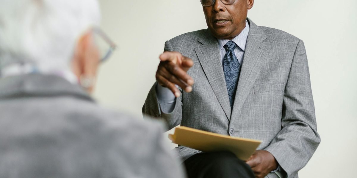 A person asking questions during an interview with a professional advisor, seeking clarity and understanding.