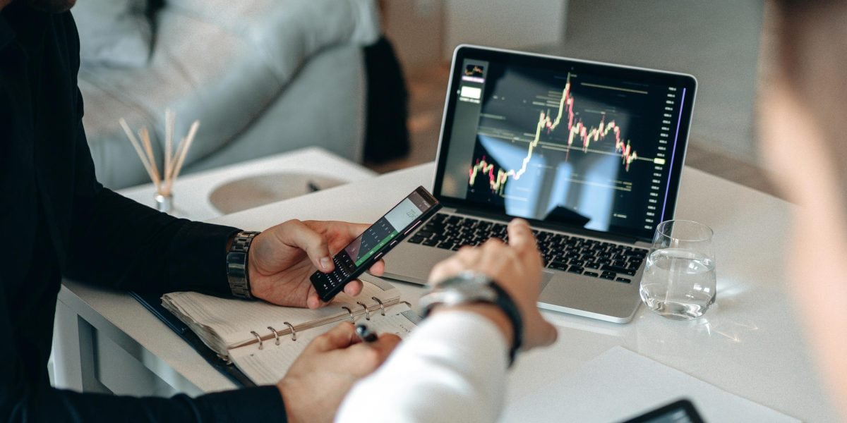 A team collaborates while analyzing financial reports and projections, crucial for long-term investment planning.