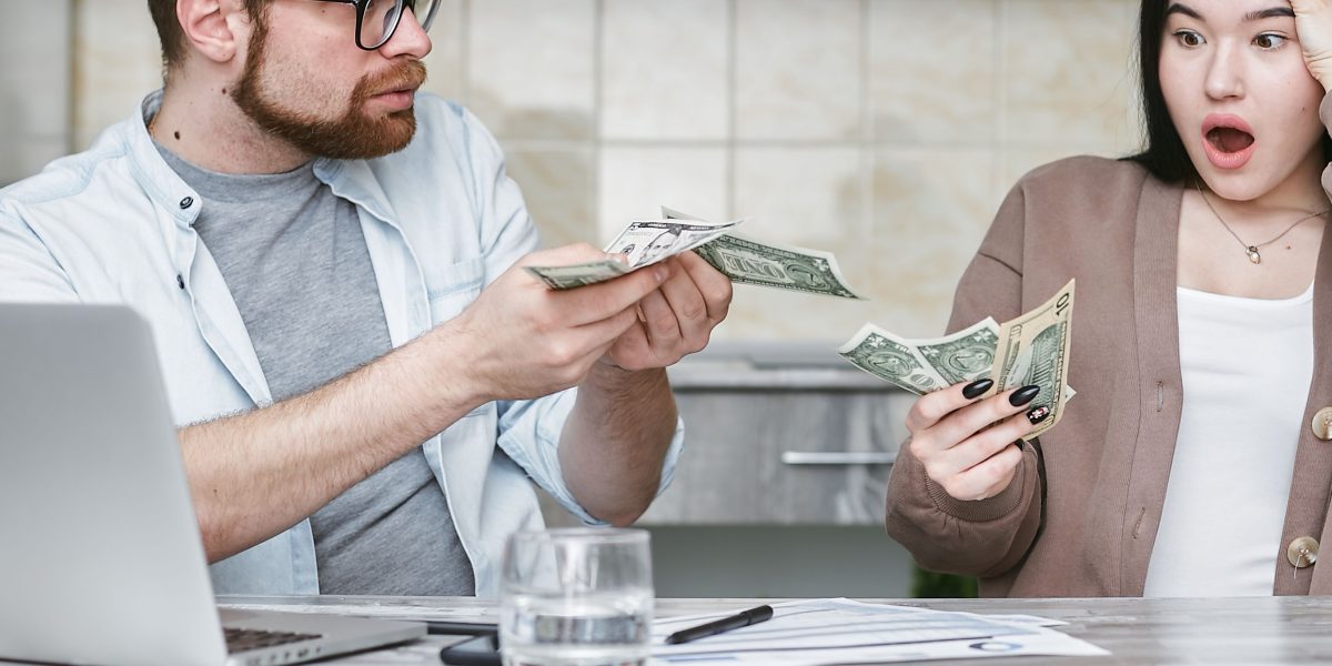 A couple discussing their financial options for a property investment, emphasizing collaborative decision-making.