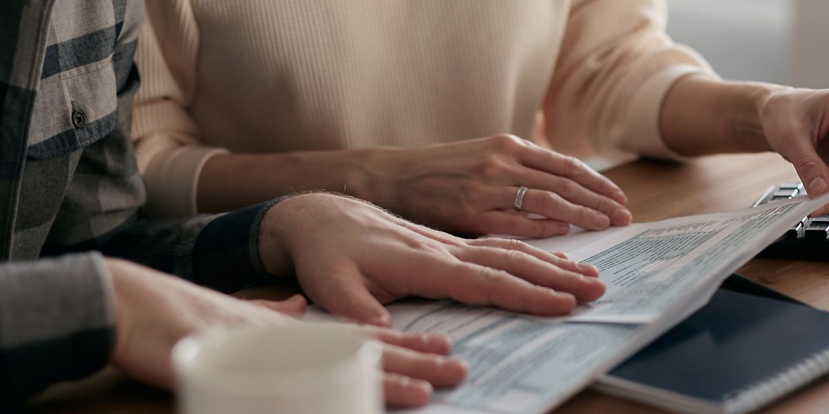 A family or couple reviewing financial documents, planning for their cross-border wealth.