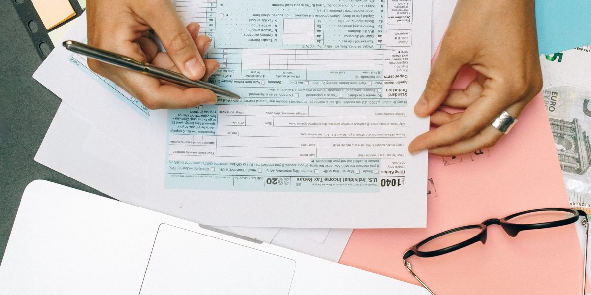 An individual thoughtfully reviewing financial documents, symbolizing the initial step into understanding what is wealth management for property investments.