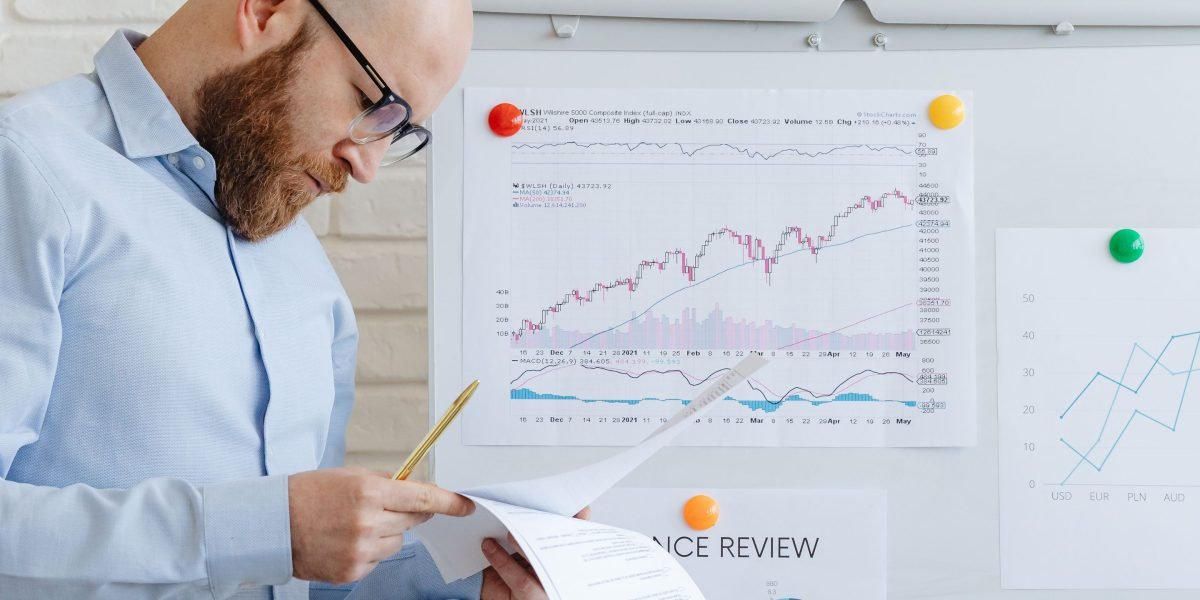 A professional individual confidently planning their next investment move in a modern office setting.