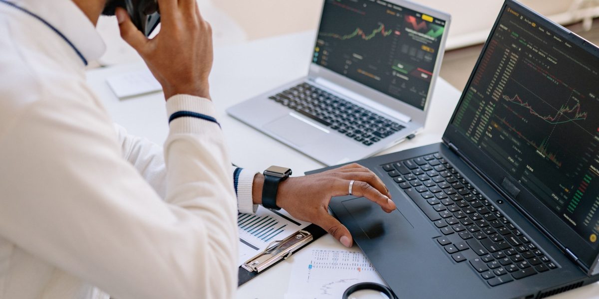A person carefully reviewing financial documents and data, representing the process of vetting real estate companies.