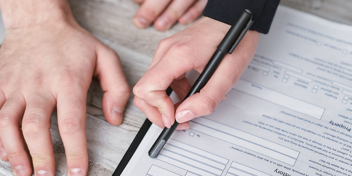 Two professionals meticulously reviewing legal documents, emphasizing the importance of due diligence in real estate investments.