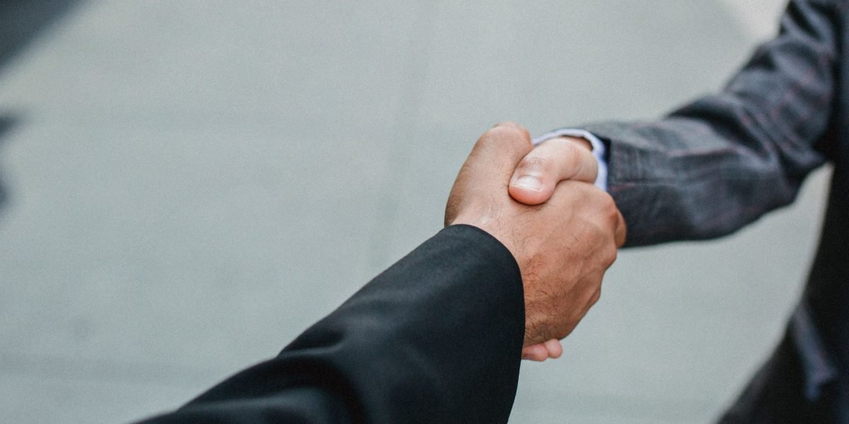 Two professionals sealing an agreement, symbolizing expert partnership in property investment.
