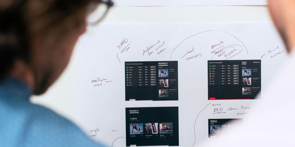A team discussing strategies at a whiteboard, illustrating collaborative risk management.