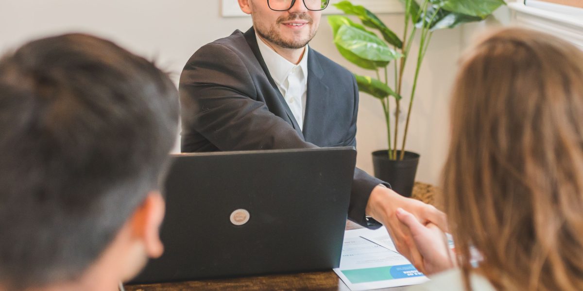 An investor discusses property goals and financial strategies with a wealth management advisor.