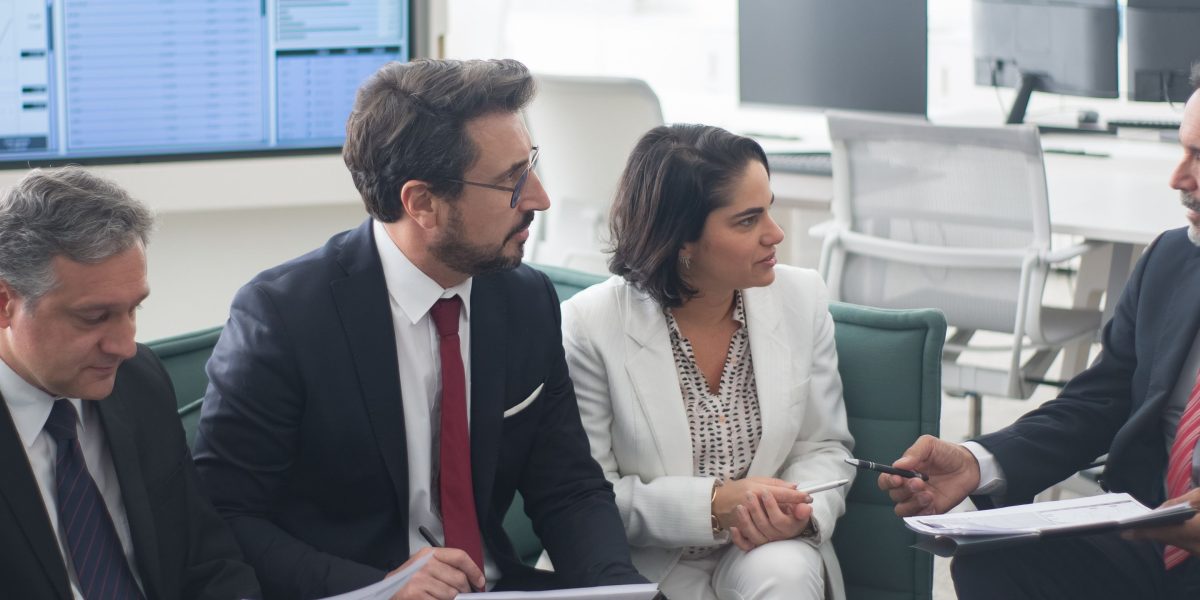 Individuals engaging in a discussion about financial goals and property investment strategies with a trusted advisor.